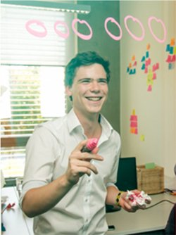 felix hartenec writing something and smiling