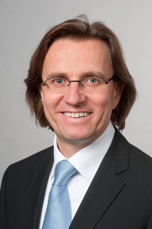 Headshot of Prof. Dr. Frank Martin Belz, a middle aged man smiling at the camera on a simple light gray background.