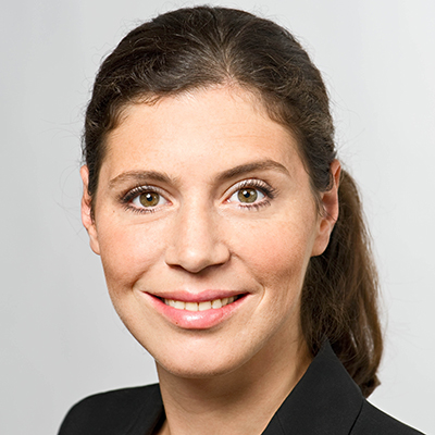 Headshot of Prof. Dr. Hana Milanov, a middle aged woman smiling on a simple grey background.